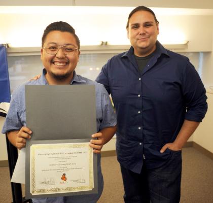 happy student displaying a scholarship they received.